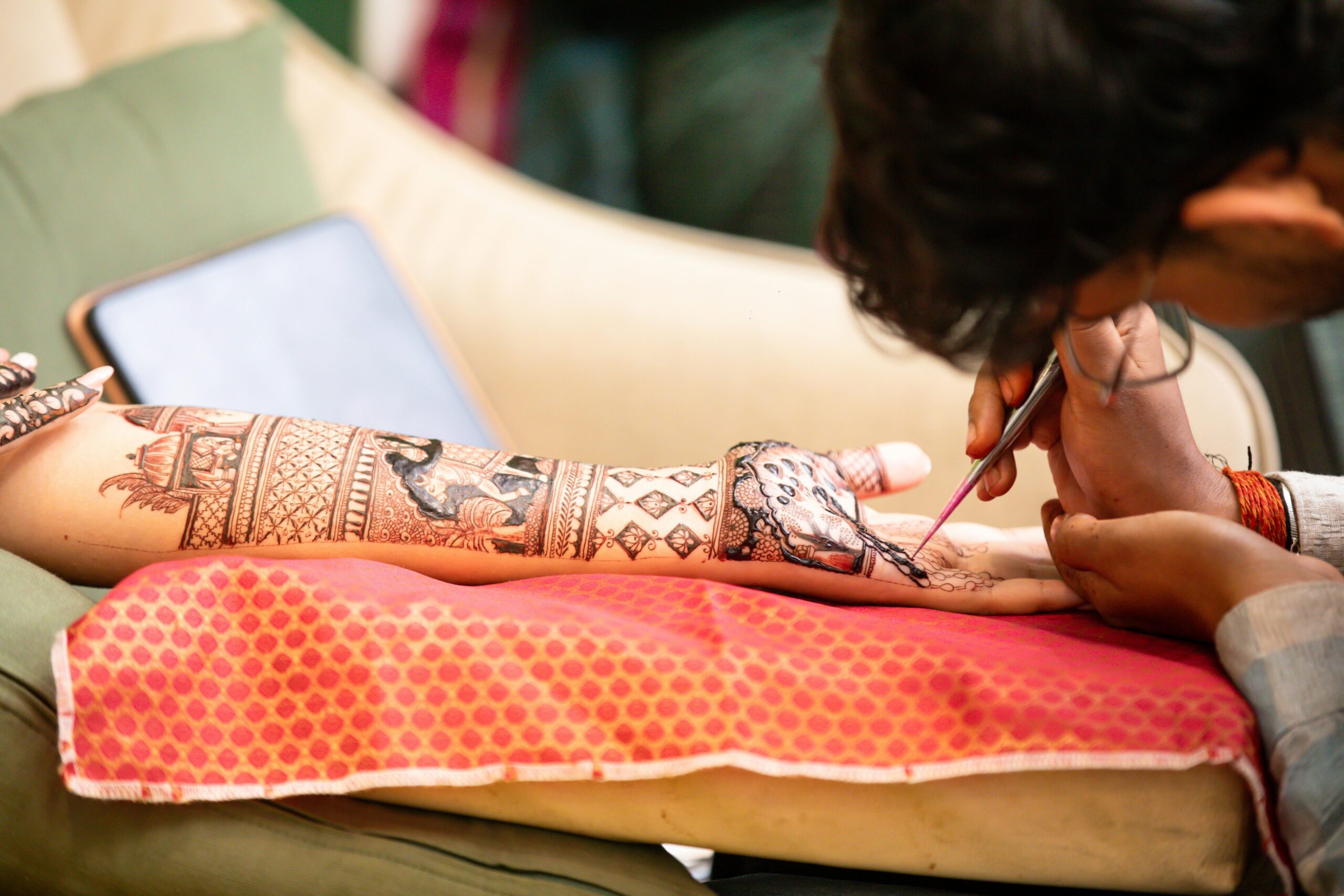Hand applying sunscreen over a gaming tattoo design
