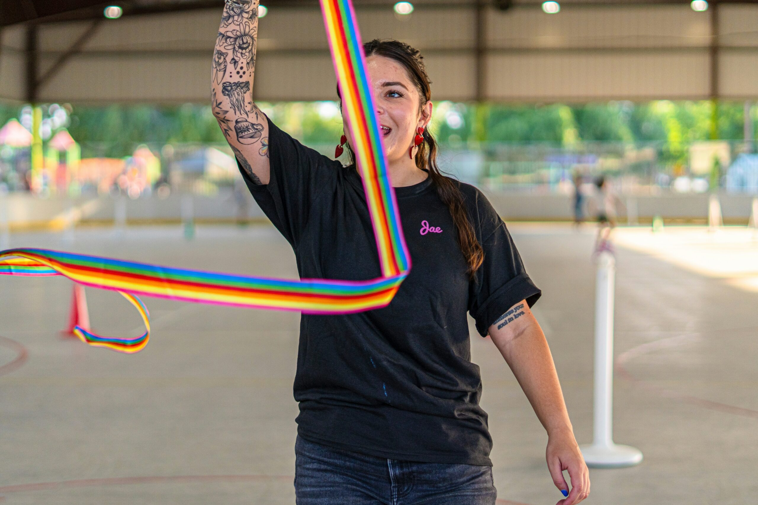 happy customer posing with vibrant gaming-themed tattoo