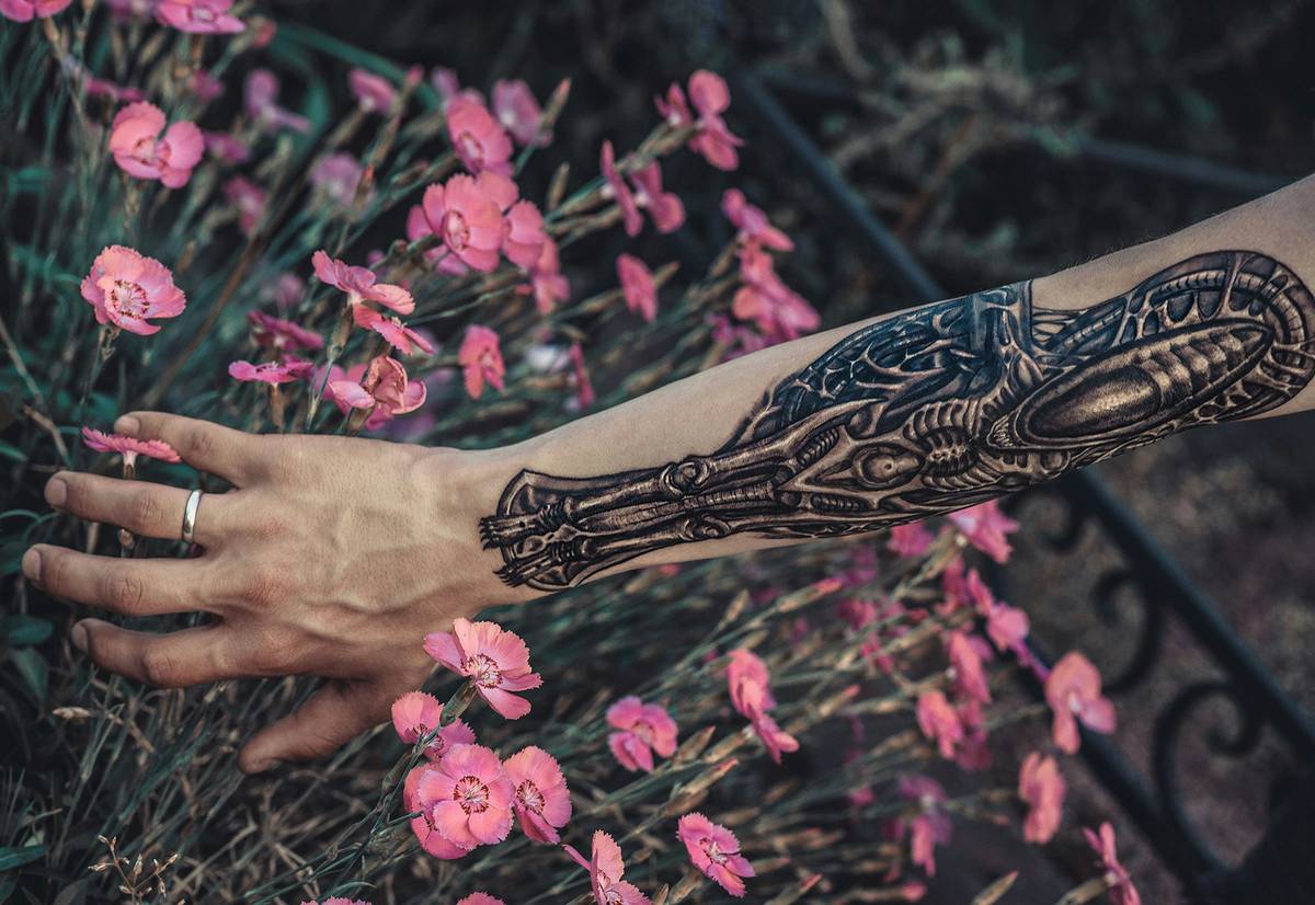 A smiling gamer proudly displaying a colorful Legend of Zelda-themed tattoo