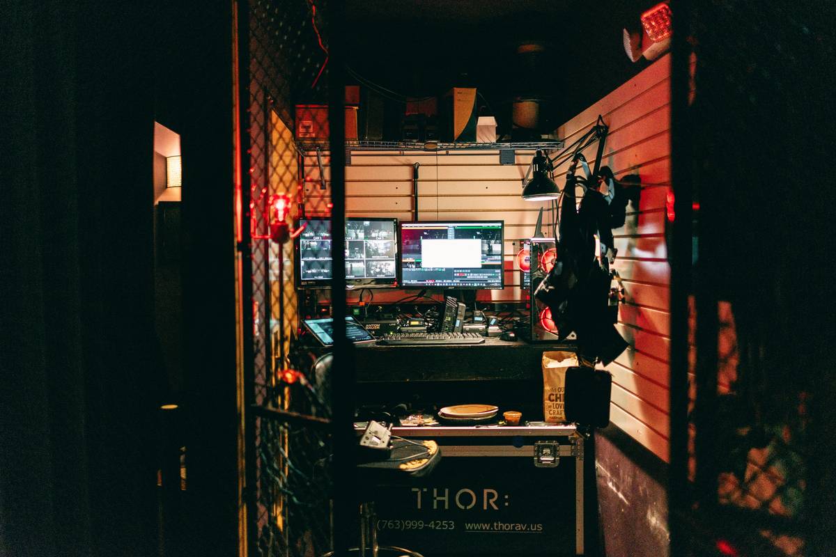 An arm tattoo depicting fragmented scenes from popular video games in glitch style.