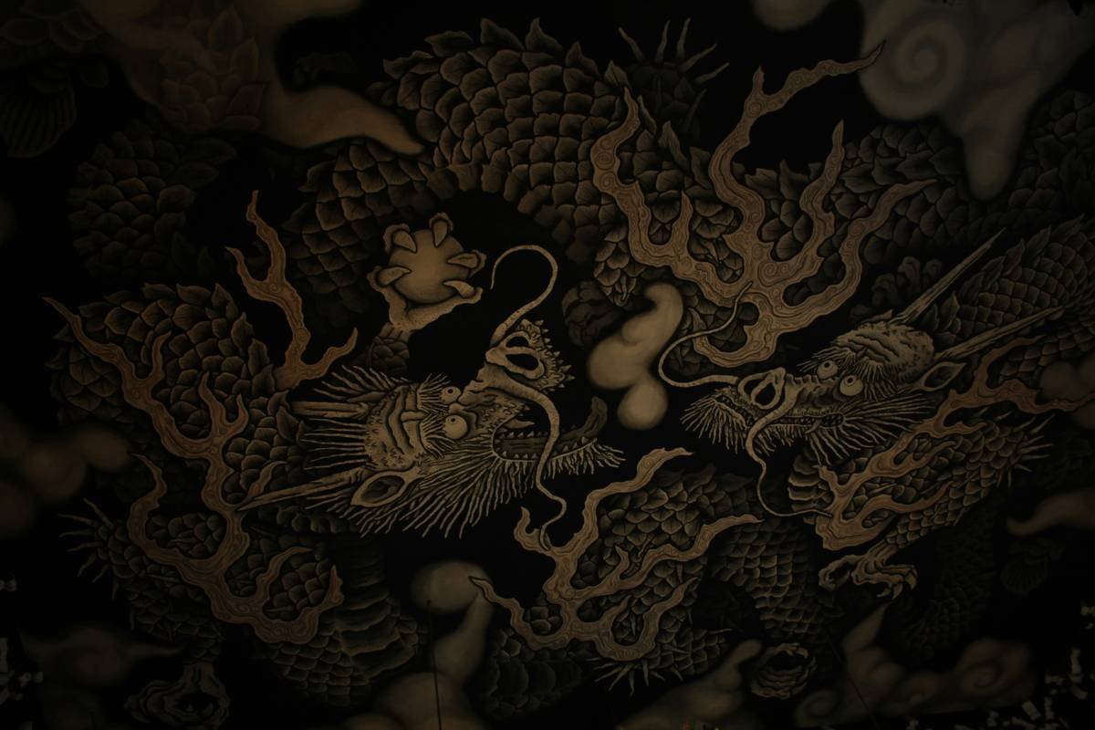 A detailed forearm tattoo featuring iconic video game characters surrounded by pixelated borders.