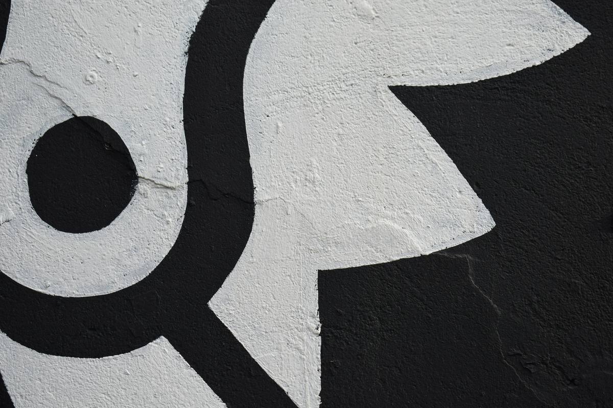 A close up of a black and white sign on a wall