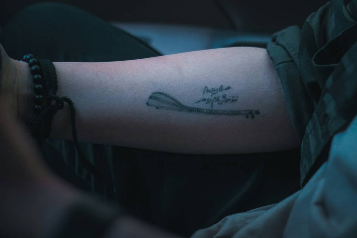 a person with a tattoo on their arm