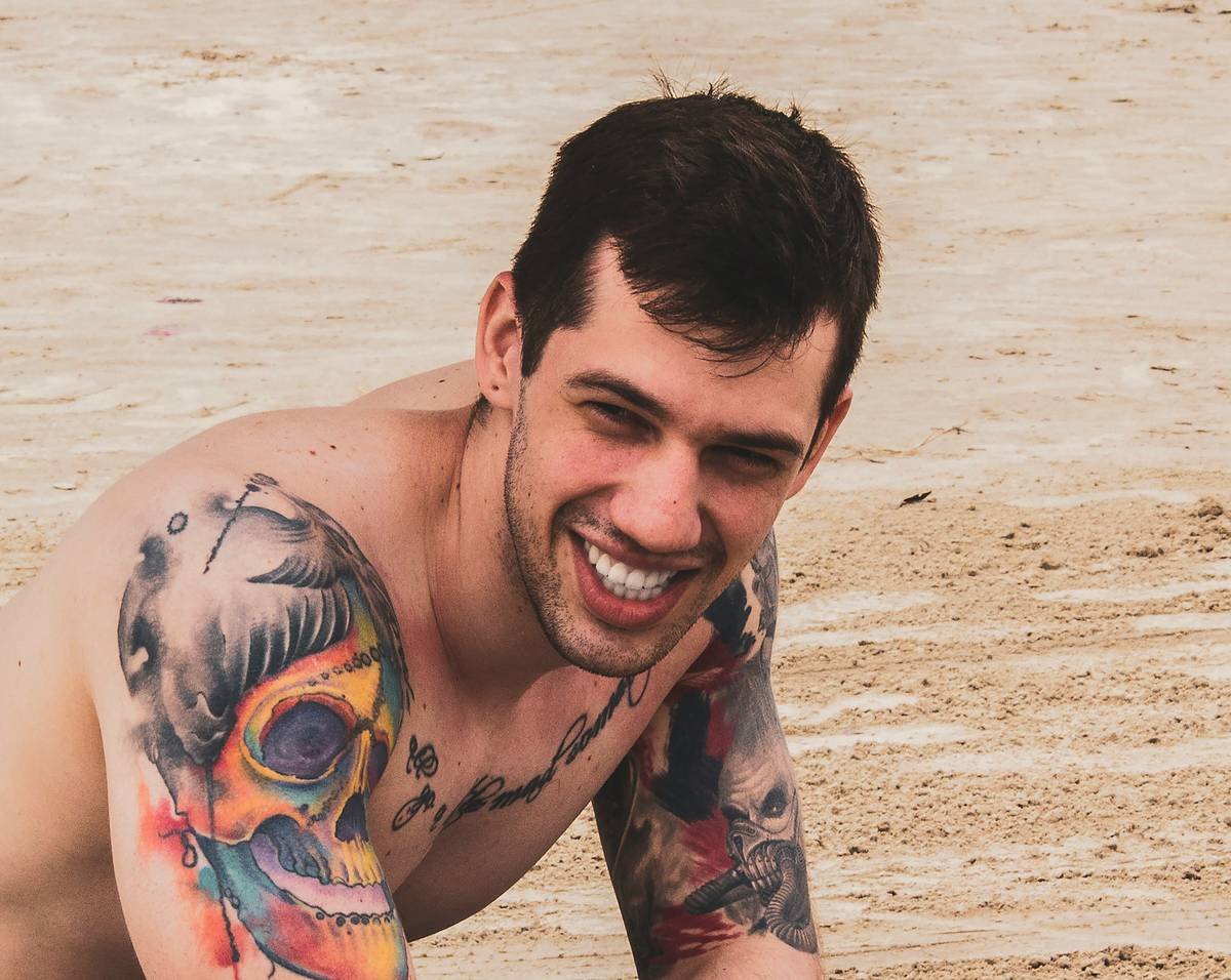 man with tattoos on his arm