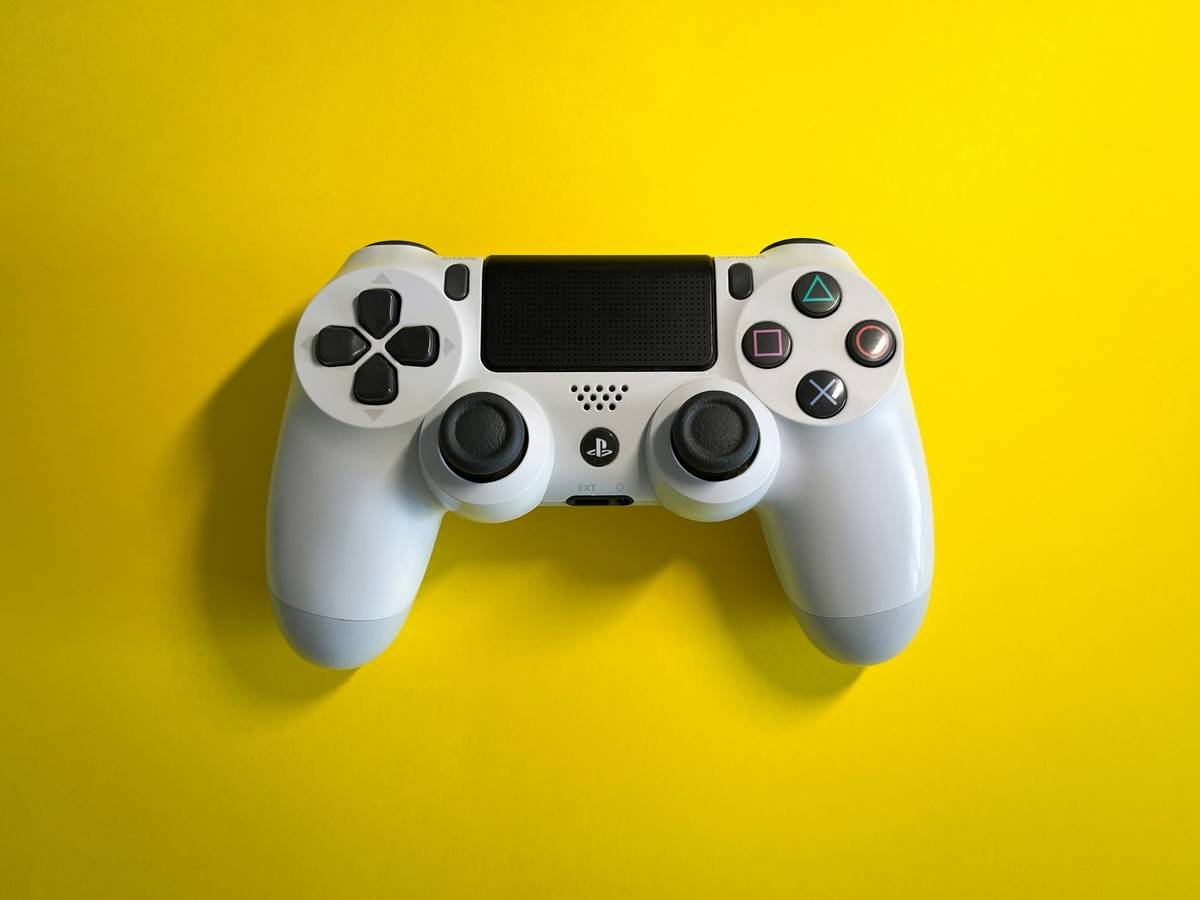 White gamepad on yellow paper