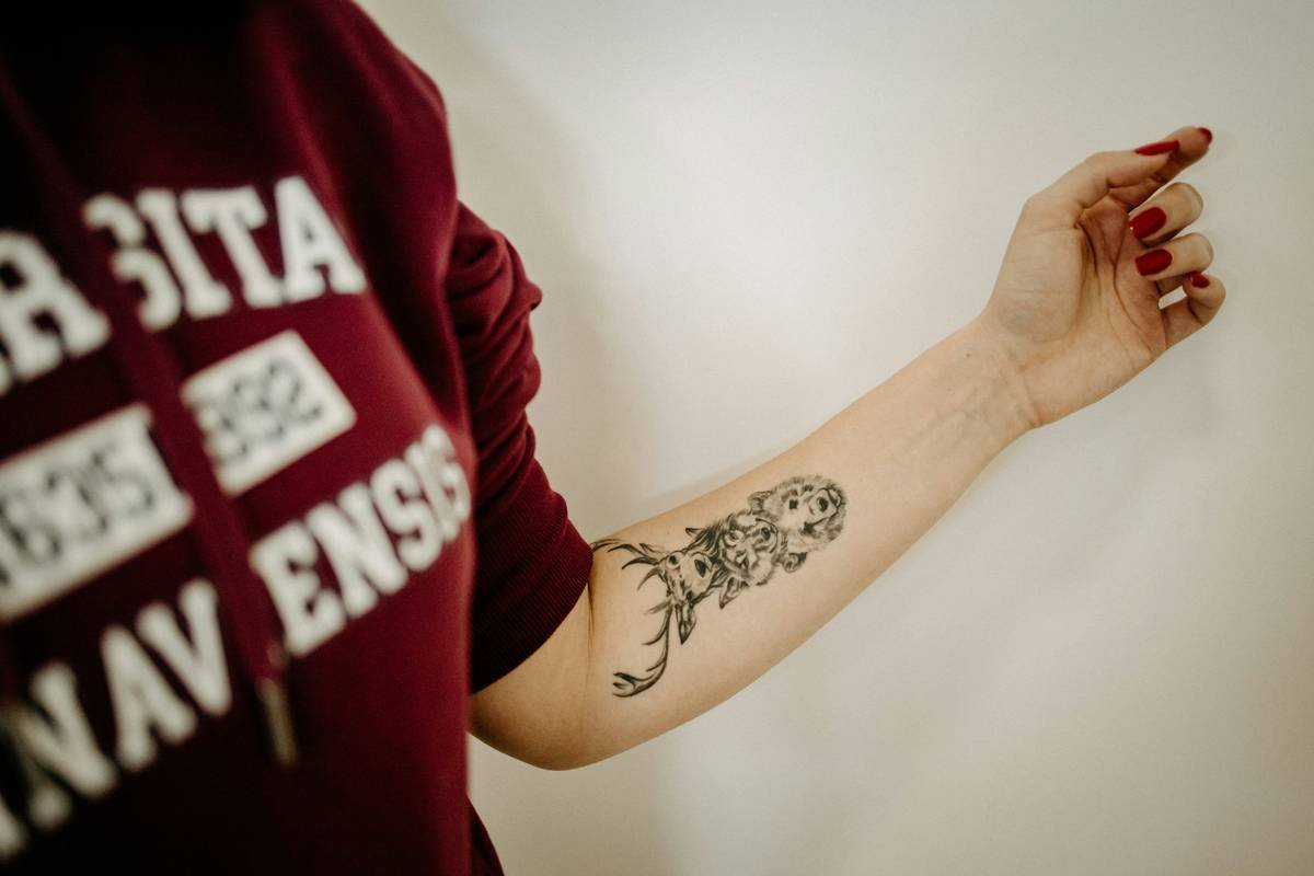 Bar chart showing 68% of gaming tattoos feature weapons, with subcategories: swords 32%, guns 24%, fantasy blades 12%. Source: International Gaming Ink Survey 2023.