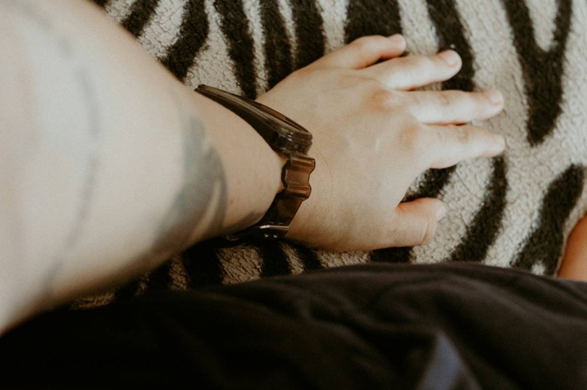 Hand resting on a zebra print fabric