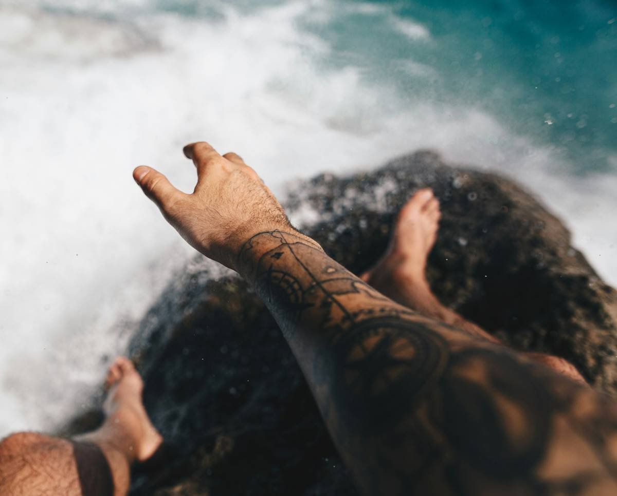 Faded vs well-maintained tattoo ocean showing impact of proper aftercare on color retention