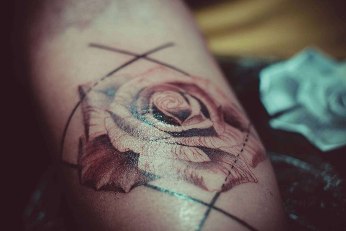 low poly tattoo design process showing anatomical mapping on forearm
