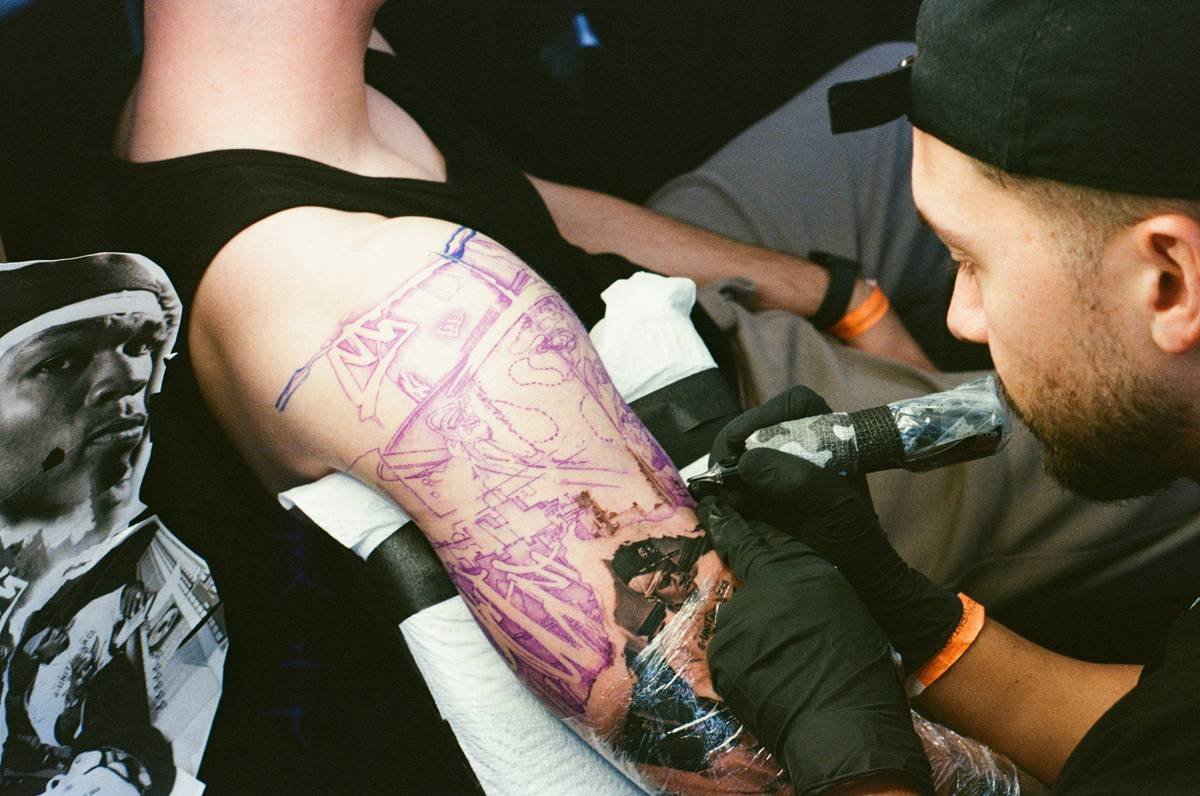 Close-up of a healing gaming tattoo showing early peeling stage, illustrating tattoo healing time