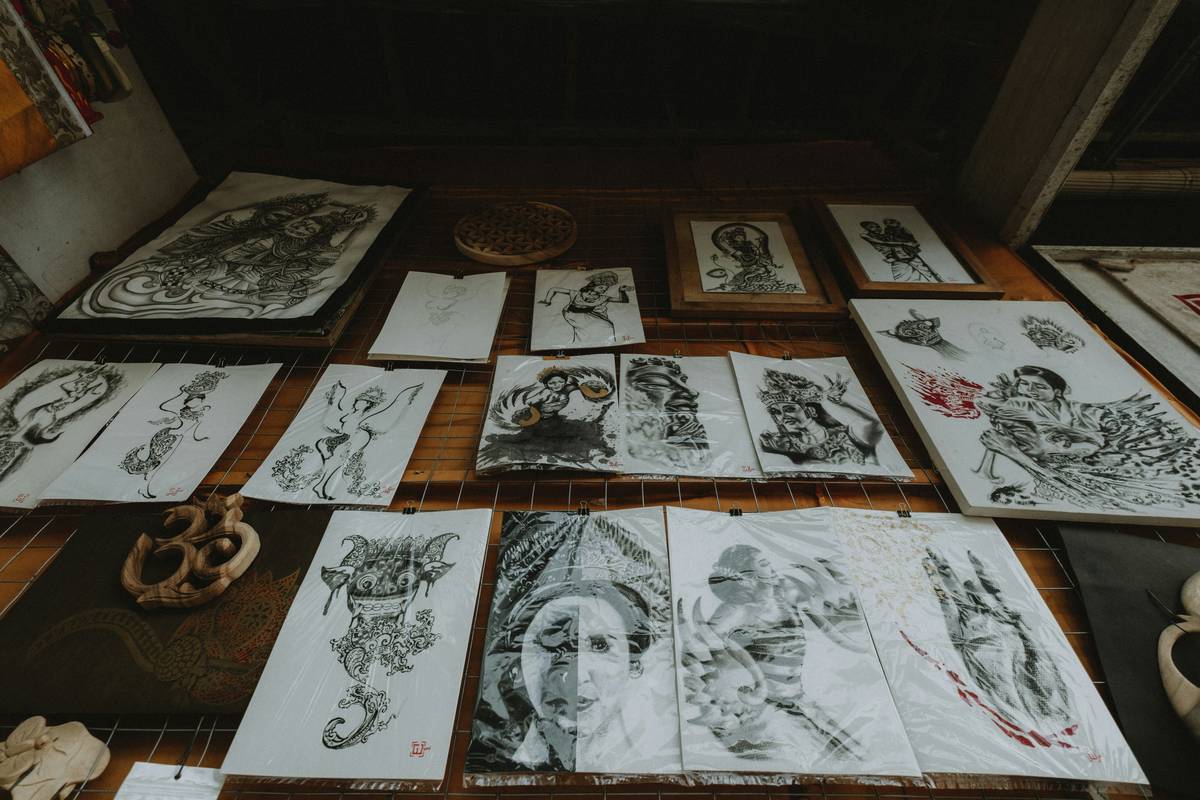 Collection of intricate drawings displayed on a wall